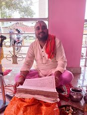 Pandit Sourabh Thakur reading Vedic scripture during a ceremony in West Bengal.